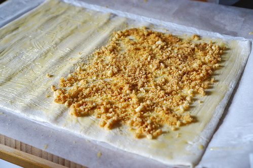 How to make a gluten free apple and walnut strudel: spreading the cookie crumbs on one half of the pastry sheet.