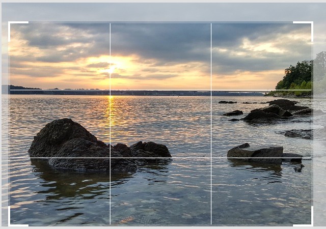 Shown is the cropping compensation of a beautiful state park sunset to follow the rule of thirds. Horizon is on a line, sunlit water follows a line, and the major rock feature out in the water falls on an intersection. This pleases your visual cortex, very much!  Bob D