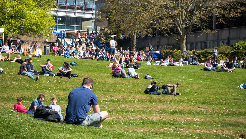 student sat on grass.