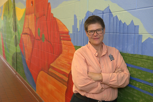 Kyes Stevens poses next to a mural