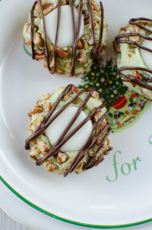 Pistachio Thumbprint Cookies - pistachio cookies with vanilla filling and a chocolate drizzle! The perfect Christmas cookie!