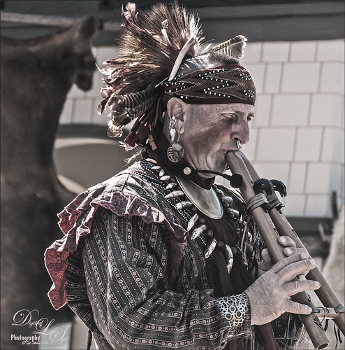 Image of a Native American playing a Drone Flute