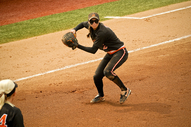 Mariah Gearhart throws to first base