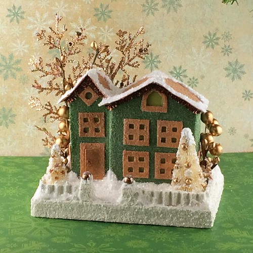 green and brown Putz house with copper embellishments