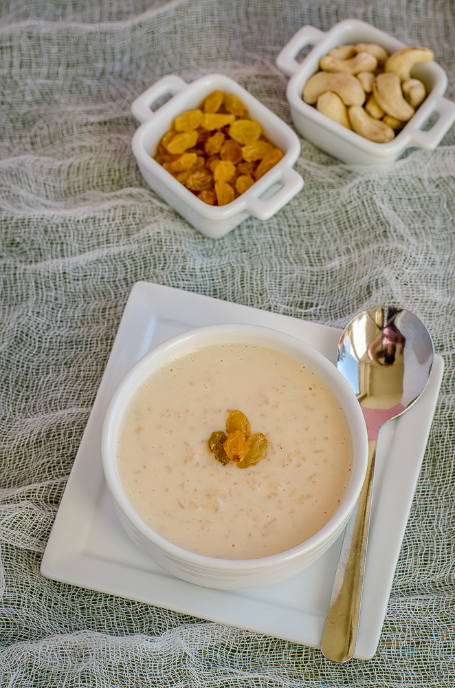 a bowl of caramel kheer in place on a white square plate.
