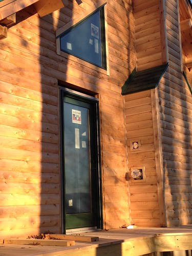 Full glass door on right side of log home