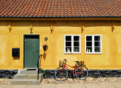 Yellow house with red bicycle