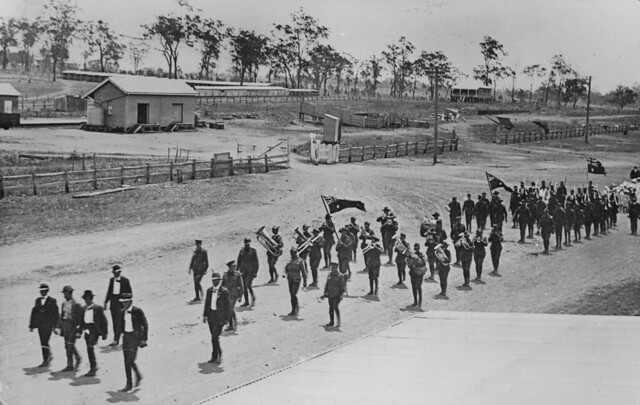 Procession of soldiers and schoolchildren led by a brass band, Biggenden, ca. 1918