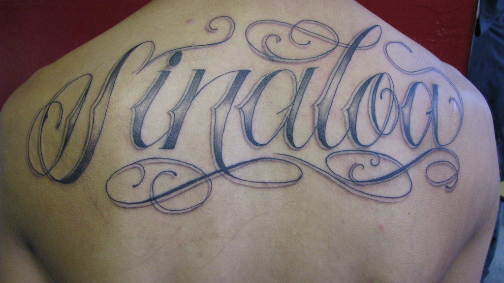Sinaloa tattoo | Tattoo that reads sinaloa in cursive on bac