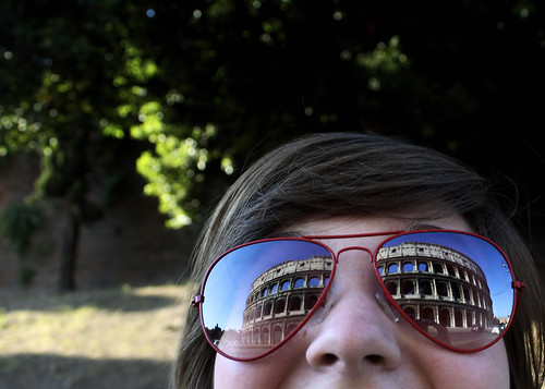 Seeing is Believing: The Colosseum shows in the reflection on a student's sunglasses in Rome, Italy.