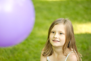 a child with a purple balloon