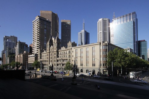Skyscrapers tower over Spring Street and Melbourne's Hotel Windsor