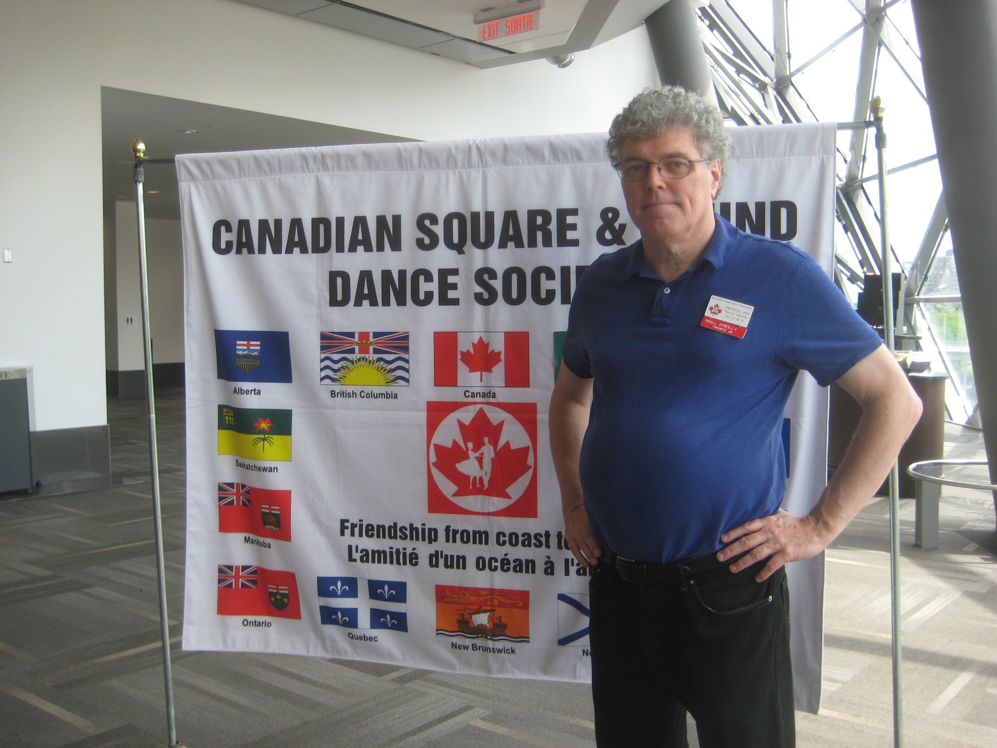 Nialll in front of Canadian Assn banner