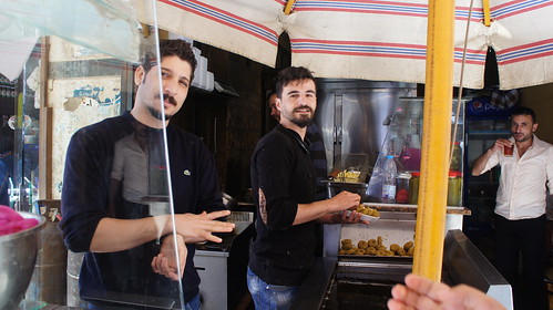 Two Syrian young men working in ful and falafel restaurant