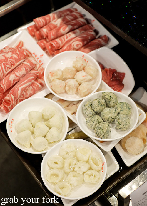 Lamb slices, shrimp balls, coriander balls and fish dumplings and fish ball roe dumplings at Shancheng Hotpot King, Sydney