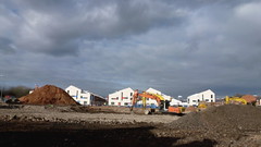 Newly constructed houses as part of Infusion Homes, with land on site of demolished bus depot in foreground -  Moss Side, Manchester, UK