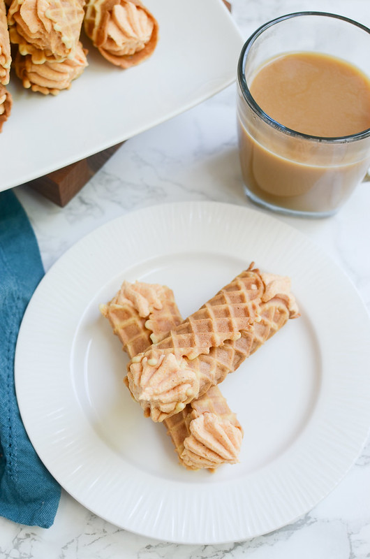 Pumpkin Pizzelle Cannoli - a twist on the classic cannoli! Pizzelle cookies with a sweetened pumpkin ricotta filling!