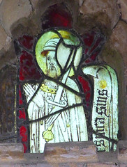 bearded saint wearing a hat and carrying a sword