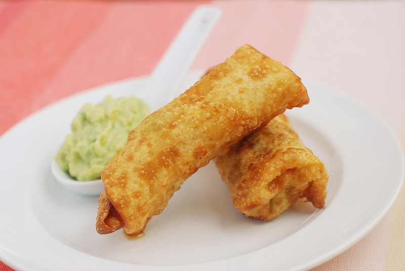 Chicken Club Egg Rolls - the most delicious egg roll recipe! Filled with chicken, bacon, avocado, and cheddar cheese. Plus, an amazing avocado ranch dipping sauce! 