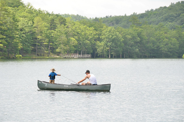 Father and son fishing from a canoe at Douthat State Park in Virginia