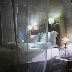 Ngoma Safari Lodge canopy bed by night.  #lodge #canopybed #travelmemo #romantic #lighting #mosquitonet #night #Botswana