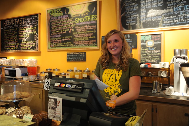 Our smiling hostess, Middle Way Cafe, Buddhist coffee house and restaurant, menus, t-shirt, Northern Lights Boulevard, Anchorage, Alaska, USA