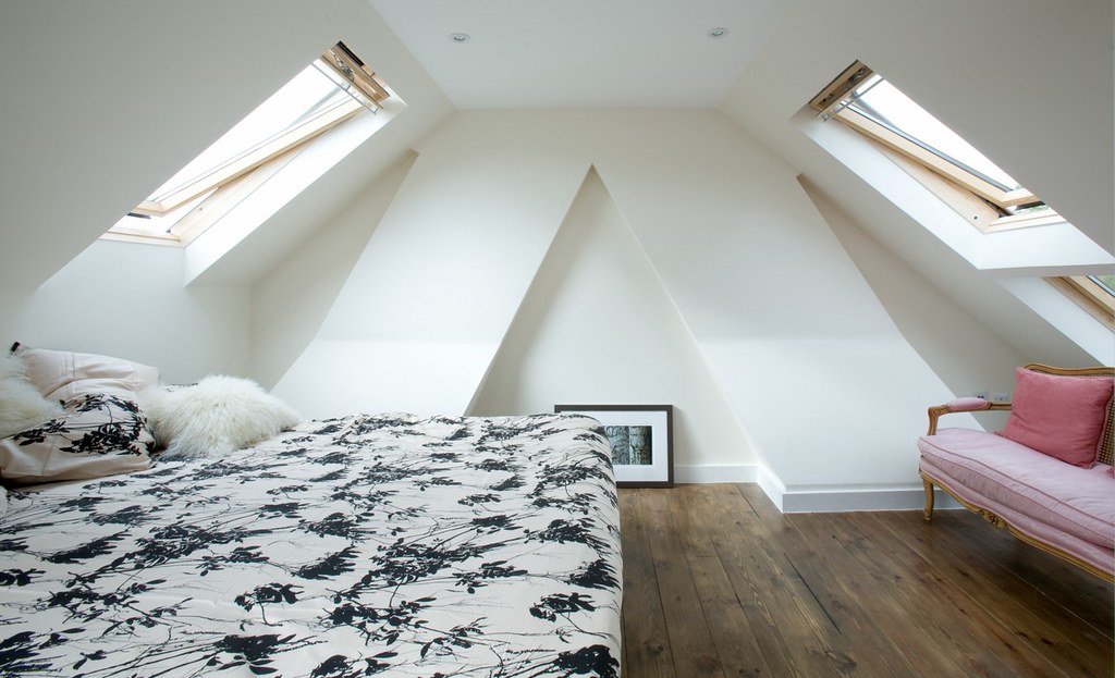 attic bedroom slanted ceiling skylight windows bed couch convert your attic into a bedroom