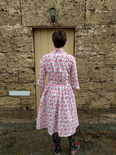 A woman in a floral print shirtdress.