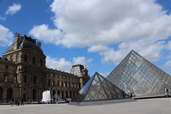 Louvre: the main square and the Pyramids reflecting the light upon the building walls