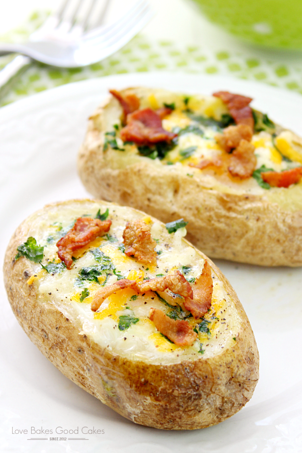 Bacon & Egg Stuffed Baked Potatoes on a white plate with a fork.