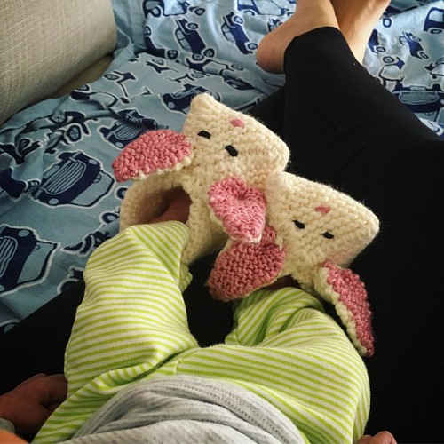 One of us has handknit bunny slippers, the other is a little envious. Thanks @mamason60 ! #motherhood #knitting #bunnyslippers #newborn #littlefeet #warmfeet #madewithlove