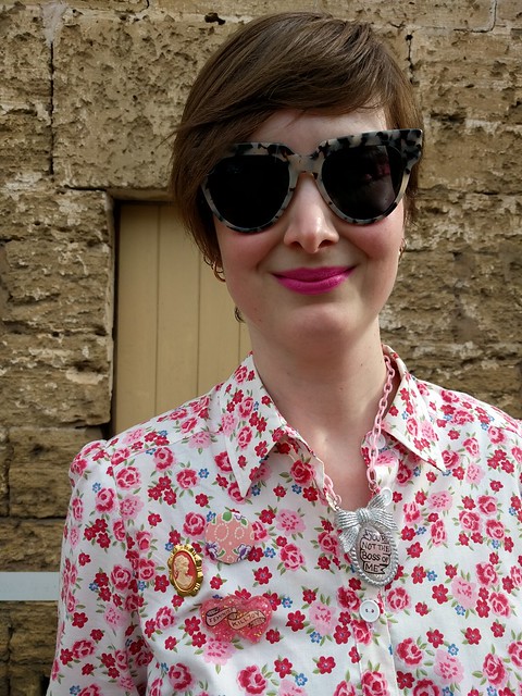 A woman wears a floral print shirtdress.