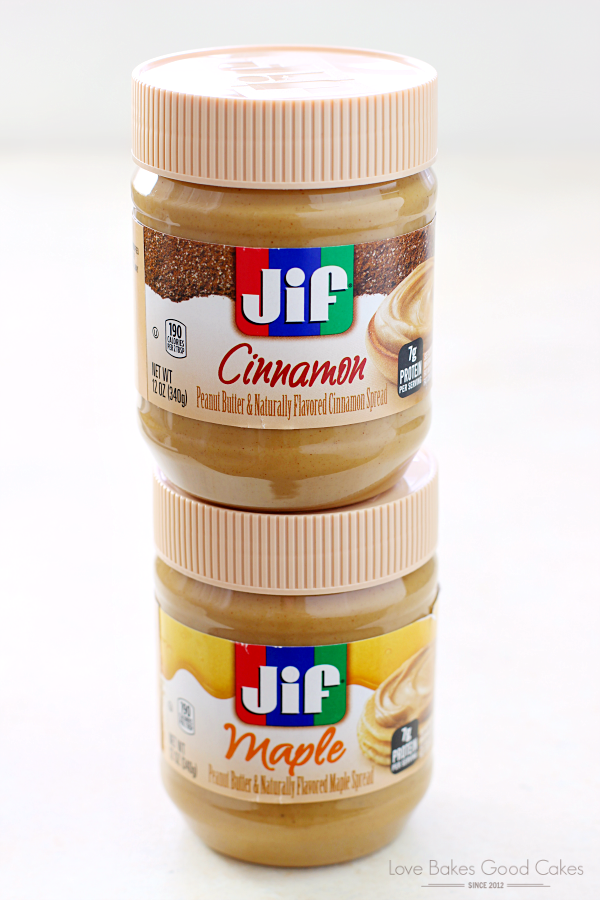 Two jars of Jif peanut butter in Cinnamon and Maple flavors.