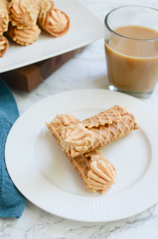 Pumpkin Pizzelle Cannoli - a twist on the classic cannoli! Pizzelle cookies with a sweetened pumpkin ricotta filling!