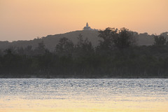 Sunset behind  Monte Belo Lighthouse from across the Limpopo River