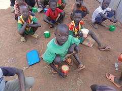 Sudanese refugee children enjoying mealtime.