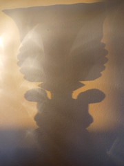 E3247934 .. Two lamp Cherubs shadow dance in the fading light of day.