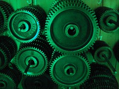 Old cog wheels illuminated by green light