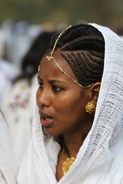 Ethiopian woman with traditional hairstyle and ornament 