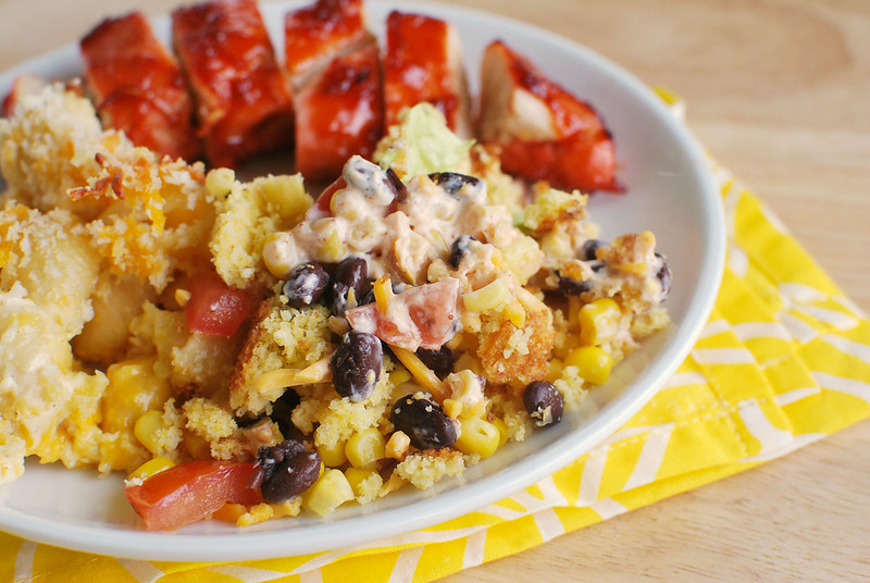 Southwestern Cornbread Salad - layers of lettuce, black beans, corn, tomatoes, red onion, cheese, and cornbread in a zesty dressing! Perfect for barbecues!