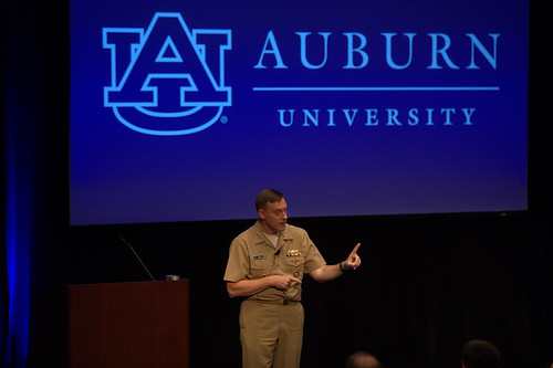 Navy Adm. Michael Rogers talks to an audience in an auditorium.