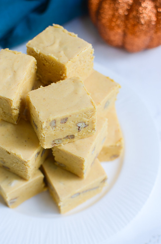 Pumpkin Pie Fudge - the taste of pumpkin pie in delicious fudgy bites! Pumpkin, white chocolate, marshmallows, and walnuts for a bit of crunch! Perfect for cookie tins at the holidays!
