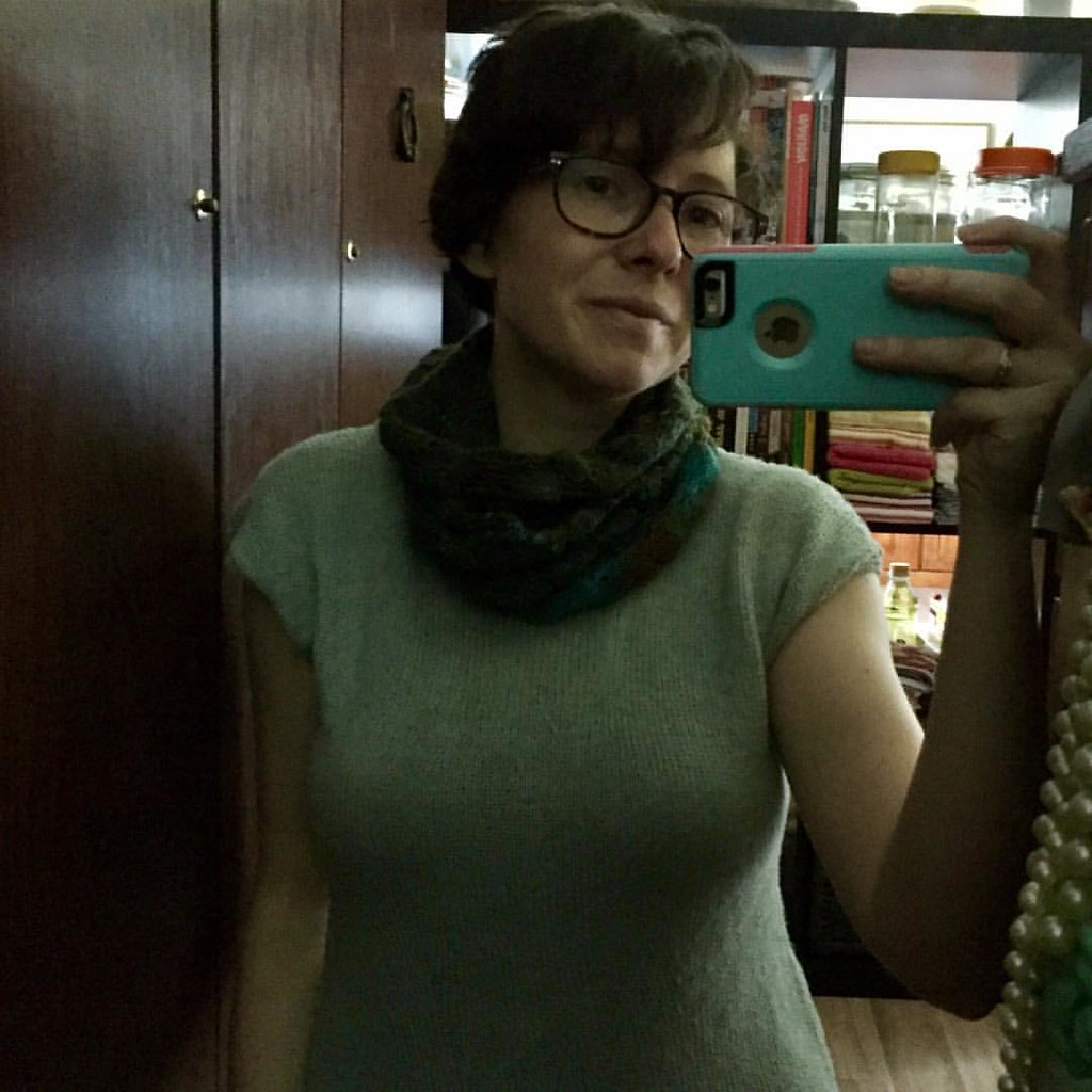 selfie wearing handknit alcomar top and whorl cowl