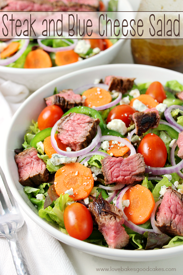 Steak & Blue Cheese Salad in a white bowl with a fork.