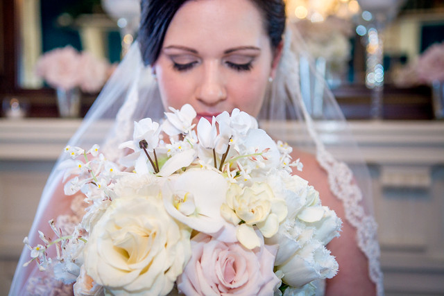 bride holding bouquet of white and pink flowers
