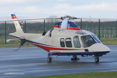 G-LCFC - 2009 build Agusta A109S Grand, pictured at City Heliport during a brief hail shower
