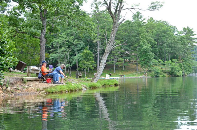 A couple spends valuable time together along the lake's edge while casting a line at Douthat State Park in Virginia