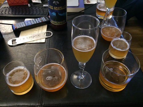 A close up shot of four different kinds of glassware each holding a yellow beer.