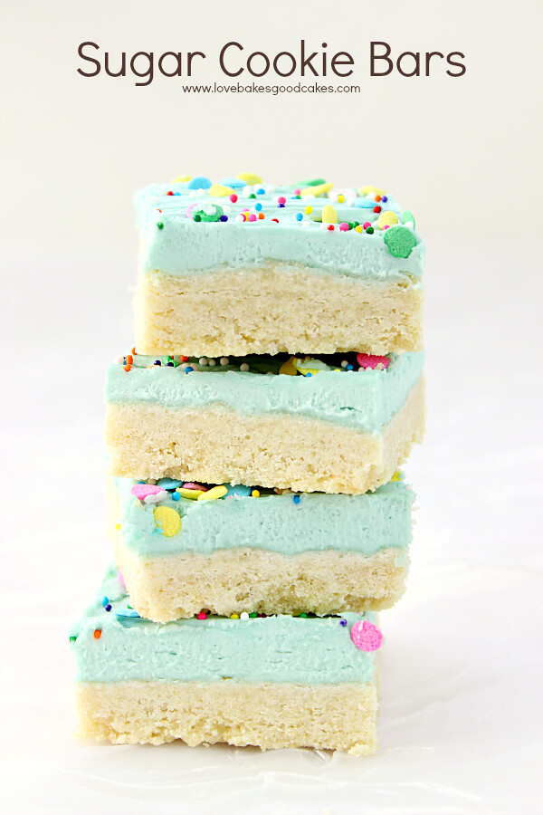 Sugar Cookie Bars stacked up on parchment paper.