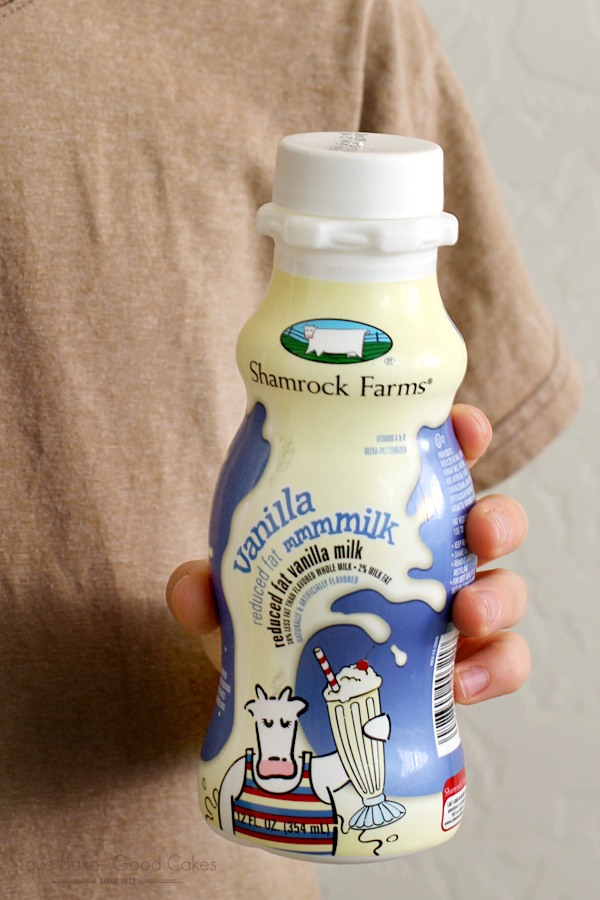 A bottle of Shamrock Farms Vanilla Milk in someone's hand.